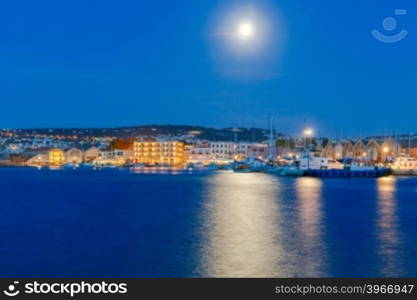 The picturesque view of the old port with the waterfront of Chania in the moonlight. Crete, Greece.