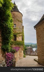 The picturesque village of La Roque Gageac backed by the cliff and reflecting in Dordogne river