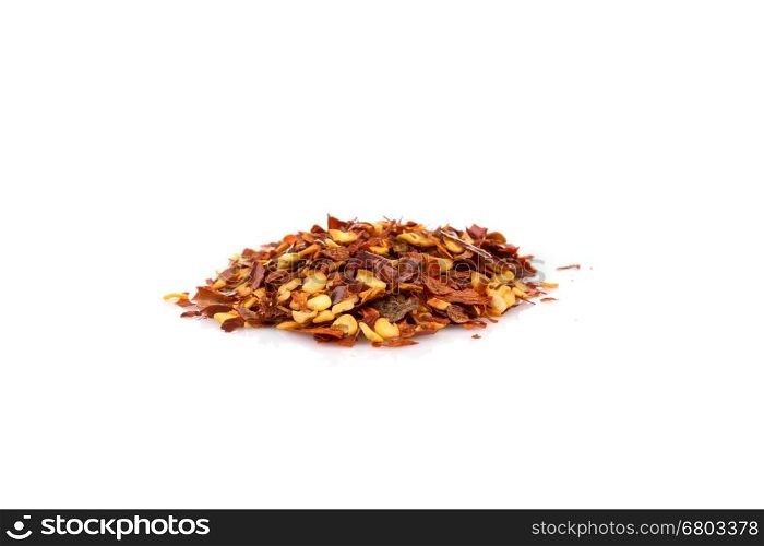 The pile of a crushed red pepper, dried chili flakes and seeds isolated on white background
