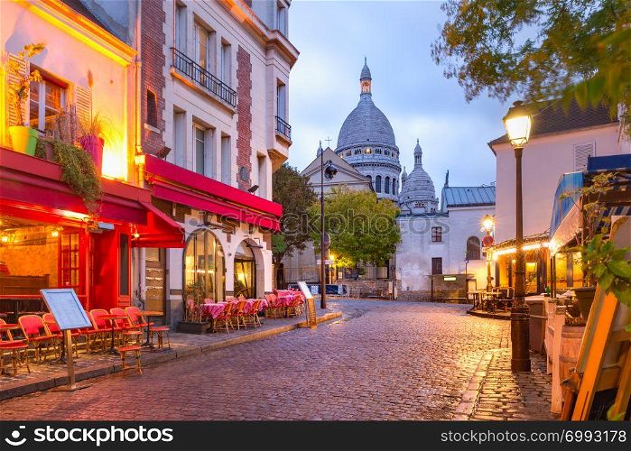 The Place du Tertre with tables of cafe and the Sacre-Coeur in the morning, quarter Montmartre in Paris, France. Montmartre in Paris, France
