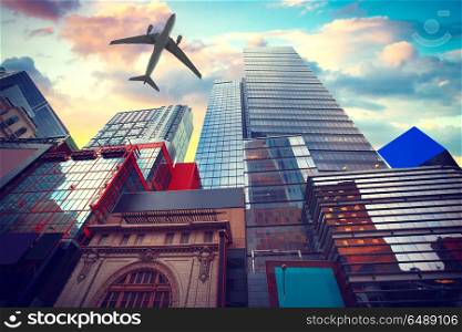 the plane flies low over the New York City Manhattan Skyline, U.S.A. colorful sunset. New York City Manhattan Skyline, U.S.A.