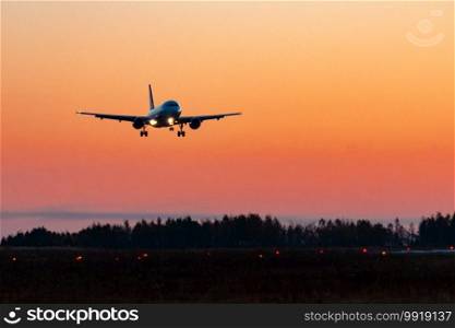 The plane lands on the runway at sunrise at high speed. Airport Khabarovsk-Novy UHHH , Russia. Airbus A319-111.. KHABAROVSK, RUSSIA - SEP 29, 2018  Aircraft Airbus A319-111 VP-BDN Aurora airline lands at the airport of Khabarovsk.