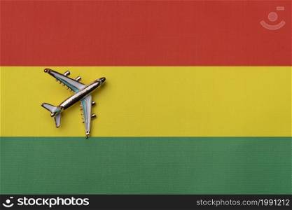 The plane over the flag of Bolivia, the concept of travel. Toy plane on the flag as a background.. The plane over the flag of Bolivia, the concept of travel.