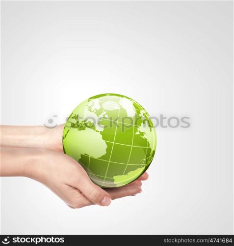 The Planet. Globe in human hand against blue sky. Environmental protection concept. Elements of this image furnished by NASA