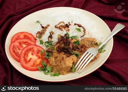 The popular south-Indian variant of Chicken Korma, incoporating coconut, served with boiled basmati rice and garnished with coriander leaves, fried onion and sliced tomato.