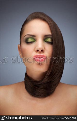 The portrait photo of beautiful woman with her hair twisted on her neck.