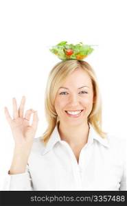 The positive girl with a salad dish on a head, isolated