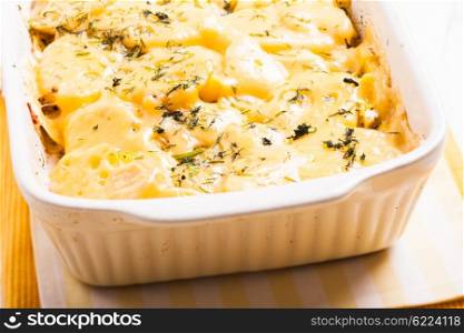 The potato casserole - baked with cheese and herbs. The potato casserole