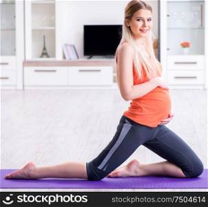 The pregnant woman doing sport exercise at home. Pregnant woman doing sport exercise at home