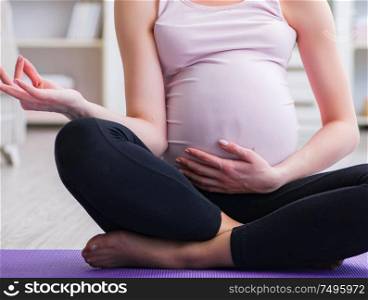 The pregnant woman exercising in anticipation of child birth. Pregnant woman exercising in anticipation of child birth