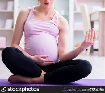 The pregnant woman exercising in anticipation of child birth. Pregnant woman exercising in anticipation of child birth