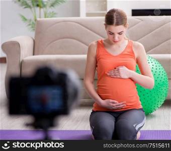 The pregnant woman recording video for blog and vlog. Pregnant woman recording video for blog and vlog