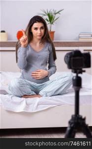 The pregnant woman recording video for her blog . Pregnant woman recording video for her blog 