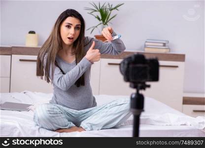 The pregnant woman recording video for her blog . Pregnant woman recording video for her blog