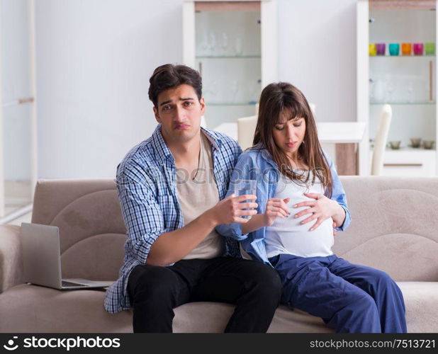 The pregnant woman with husband at home. Pregnant woman with husband at home