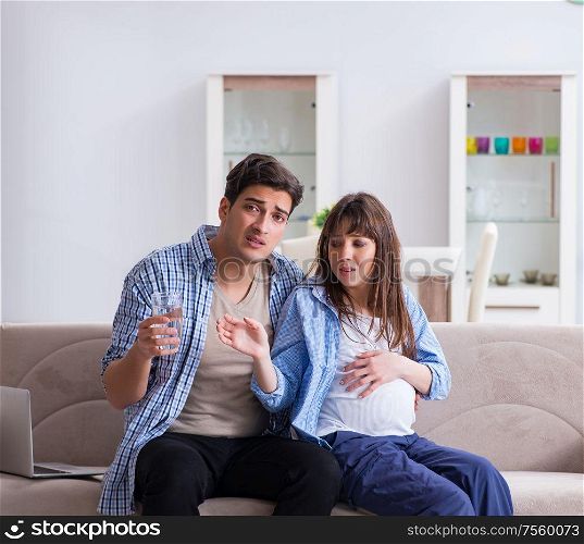 The pregnant woman with husband at home. Pregnant woman with husband at home