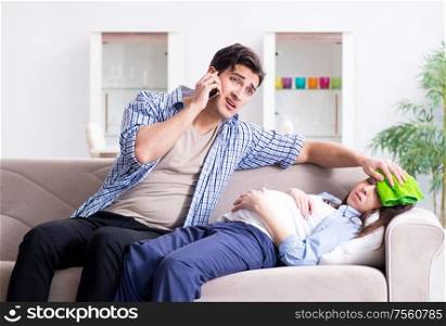 The pregnant woman with husband at home. Pregnant woman with husband at home