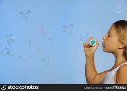 The pretty girl with bubbles heart. A blue background