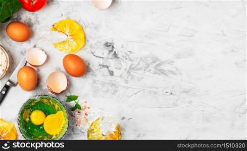 The process of making poached or benedict eggs. The cook pours an egg into a plate. Ingredients for making breakfast on the table. Top view, copy space for text. The idea of cooking.