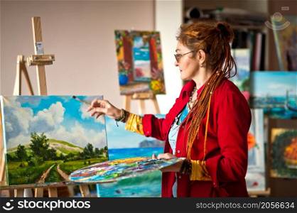 The process of painting an oil painting.. The artist paints an oil painting in her studio 2917.