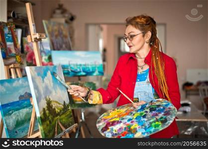 The process of painting an oil painting.. The artist paints an oil painting in her studio 2918.