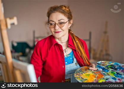 The process of painting an oil painting.. The artist paints an oil painting in her studio 2920.
