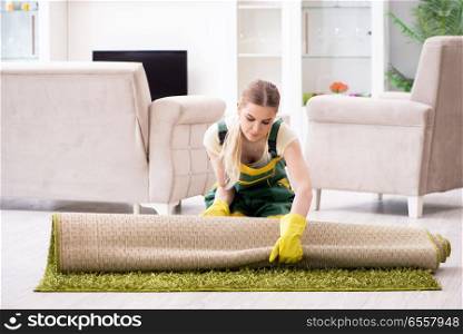 The professional female cleaner cleaning carpet. Professional female cleaner cleaning carpet