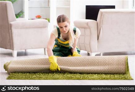 The professional female cleaner cleaning carpet. Professional female cleaner cleaning carpet