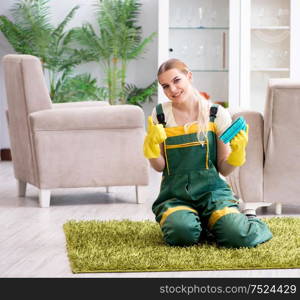 The professional female cleaner cleaning carpet. Professional female cleaner cleaning carpet