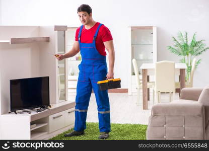 The professional repair engineer repairing broken tv. Professional repair engineer repairing broken tv