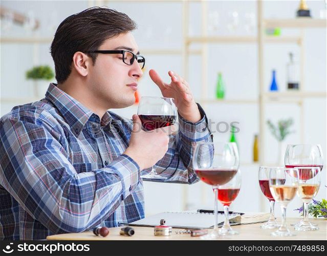 The professional sommelier tasting red wine. Professional sommelier tasting red wine