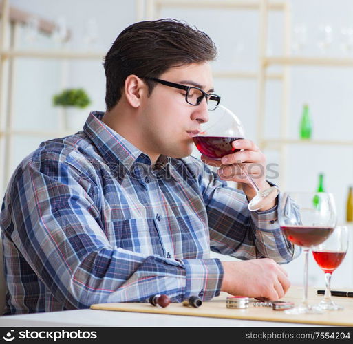 The professional sommelier tasting red wine. Professional sommelier tasting red wine