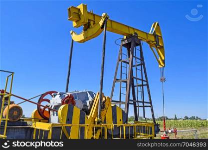The pumping unit as the oil pump installed on a well. Equipment of oil fields.. Pumping unit as the oil pump installed on a well