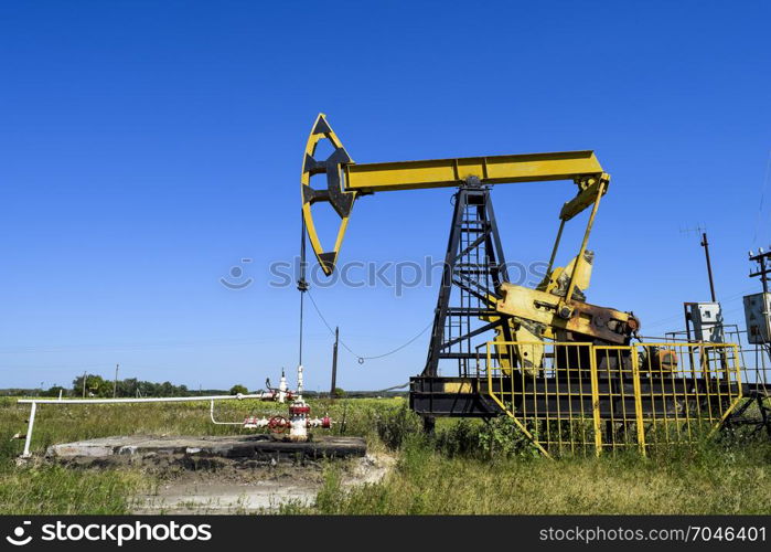 The pumping unit as the oil pump installed on a well. Equipment of oil fields.. Pumping unit as the oil pump installed on a well