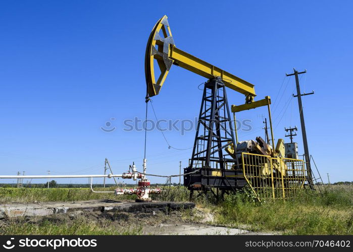 The pumping unit as the oil pump installed on a well. Equipment of oil fields.. Pumping unit as the oil pump installed on a well