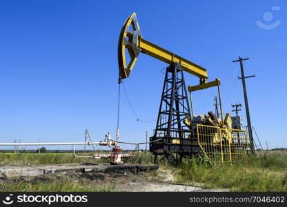 The pumping unit as the oil pump installed on a well. Equipment of oil fields.. Pumping unit as the oil pump installed on a well