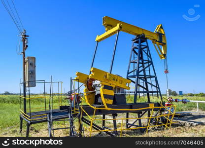 The pumping unit as the oil pump installed on a well. Equipment of oil fields.. Pumping unit as the oil pump installed on a well