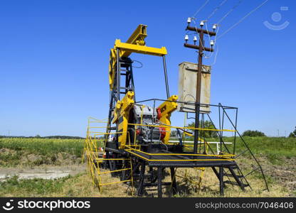 The pumping unit as the oil pump installed on a well. Equipment of oil fields.. Pumping unit as the oil pump installed on a well