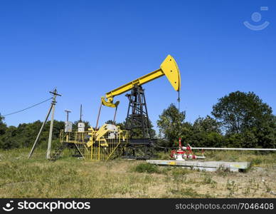 The pumping unit as the oil pump installed on a well. Equipment of oil fields.. Pumping unit as the oil pump installed on a well