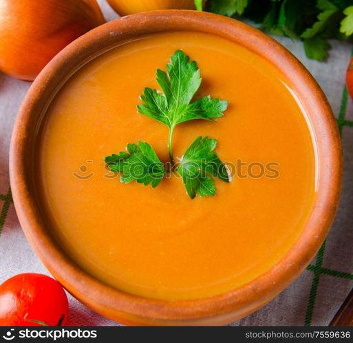 The pumpkin soup served on the table in bowl. Pumpkin soup served on the table in bowl