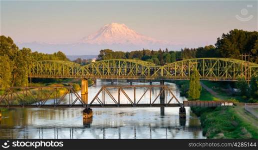The Puyallup River meanders down from the glaciers on Mount Rainier under bridges through cities on it&rsquo;s way to Puget Sound