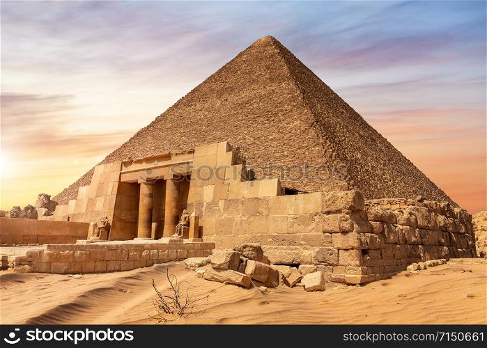 The Pyramid of Cheops and the temple entrance, Giza, Egypt.. The Pyramid of Cheops and the temple entrance, Giza, Egypt