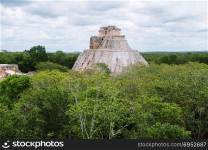 The pyramid of Magician (El Adivino) located in Yucatan, Mexico. This pyramid is the tallest and most recognizable and is the central structure in Maya ruin complex of Uxmal. The city of Uxmal was designated a UNESCO World Heritage Site in 1996. The Pyramid of the Magician in Uxmal, Yucatan, Mexico