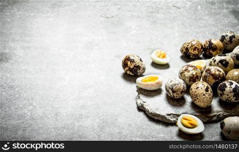 The quail eggs. On the stone table.. The quail eggs.