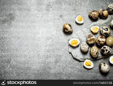 The quail eggs. On the stone table.. The quail eggs.