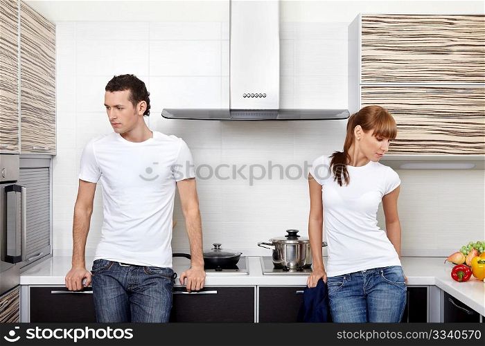 The quarrelled man and the woman on kitchen