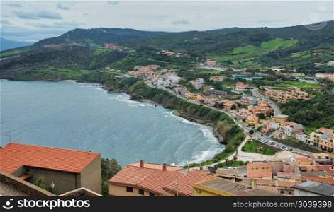the raod to castelsardo seen from the highest point of the city with the ocean as background. skyline of castelsardo with the road