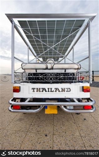 The rear of a solar powered tuc tuc, with the text Thailand
