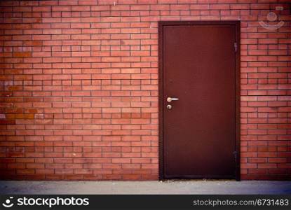 the Red brick wall and the iron closed door