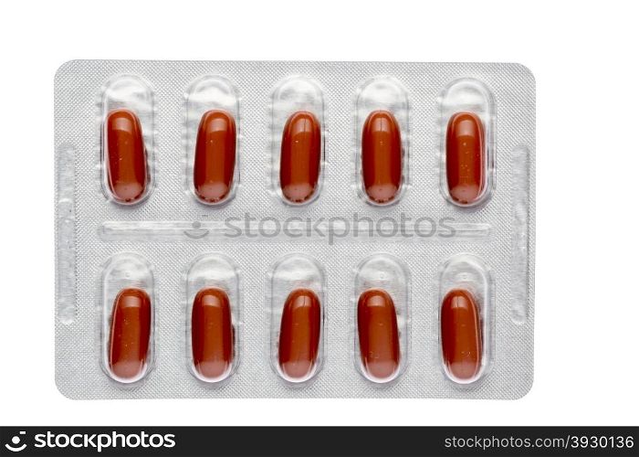 The red capsules in a blister on isolated background. The red capsules in a blister